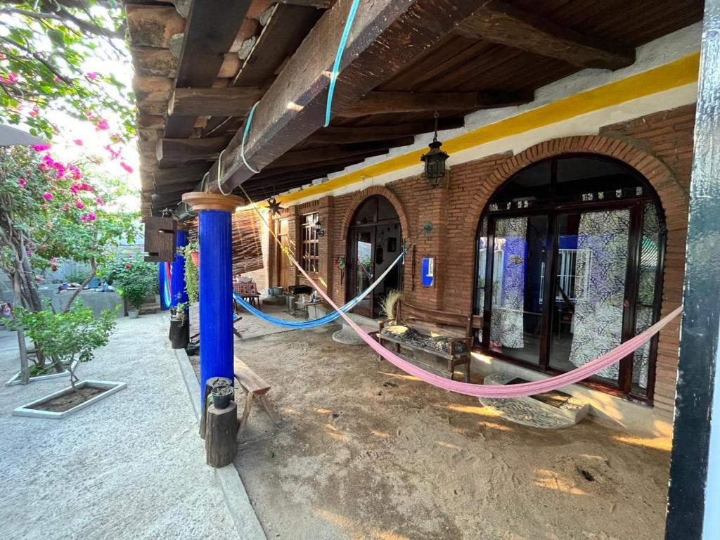 a building being remodeled with a long hose at Surf Casita Mexicana Next to Playa San Diego in Santiago Astata