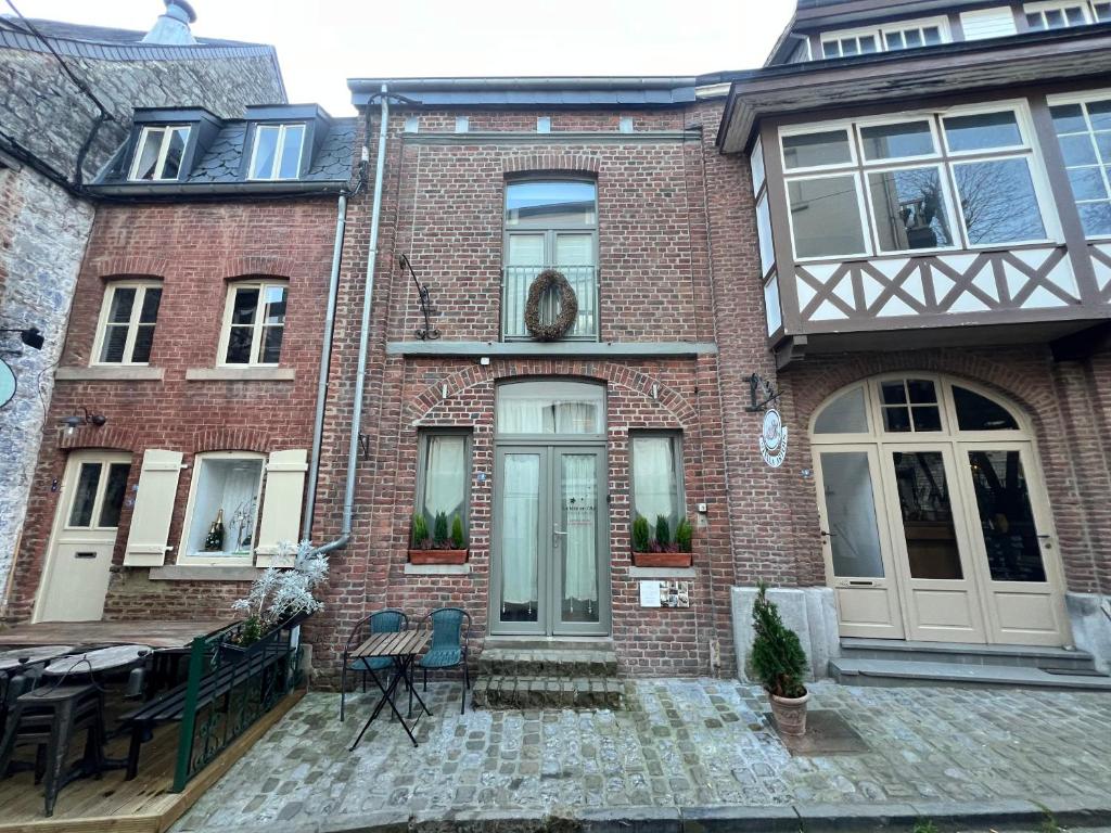 a brick house with a front door and a patio at Les Etoiles studio in Durbuy