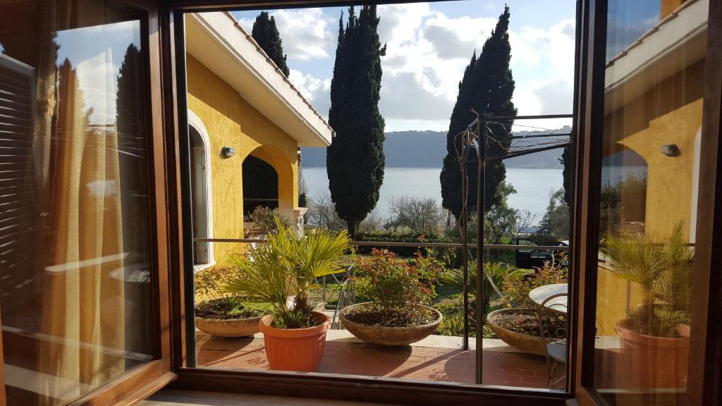 a window with a bunch of potted plants at Il Nido del Falco in Castel Gandolfo