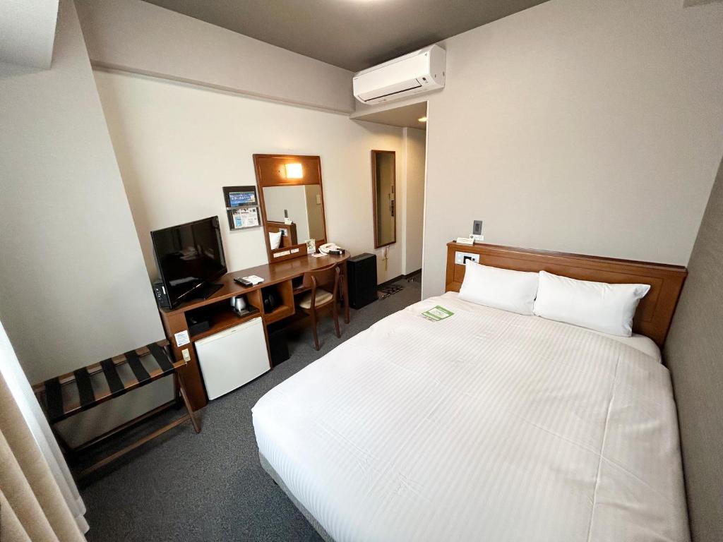 Postel nebo postele na pokoji v ubytování Hotel Route-Inn Iwata Inter