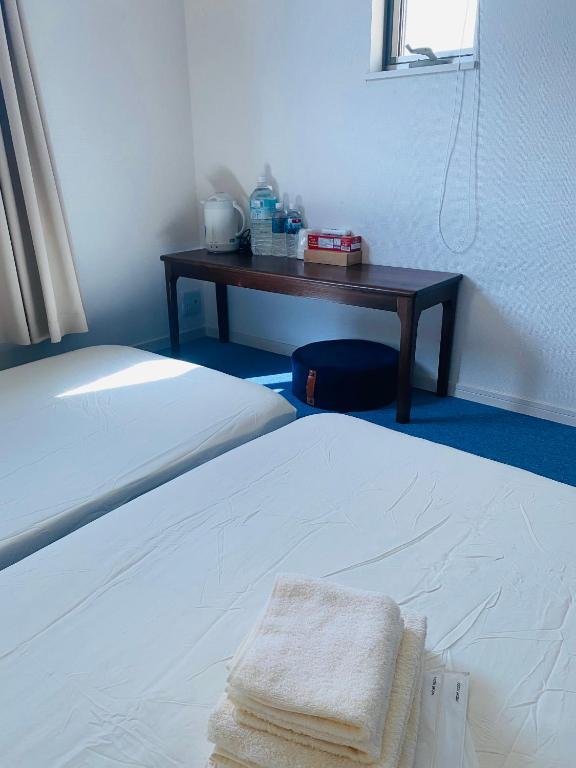 Postel nebo postele na pokoji v ubytování 絵ちゃんの家