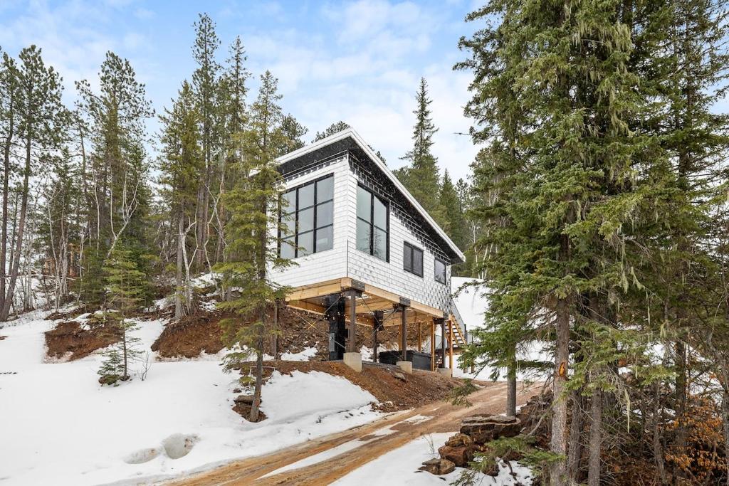 a house in the woods in the snow at Reflection Ridge in Lead