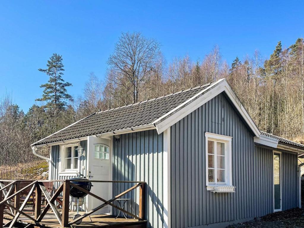 a small grey and white shed with a porch at 3 person holiday home in ÖDSMÅL in Ödsmål