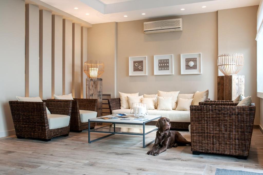 a living room with a couch and chairs and a table at Astoria Hotel in Vico Equense