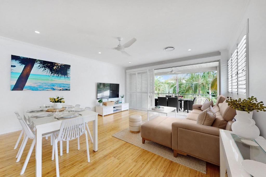 a living room with a couch and a table at 19 Colonial in Noosaville