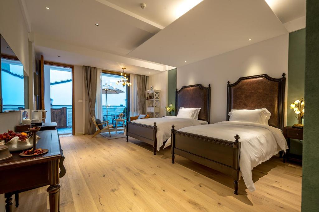 Postel nebo postele na pokoji v ubytování Moganshan Xinyuanju Homestay