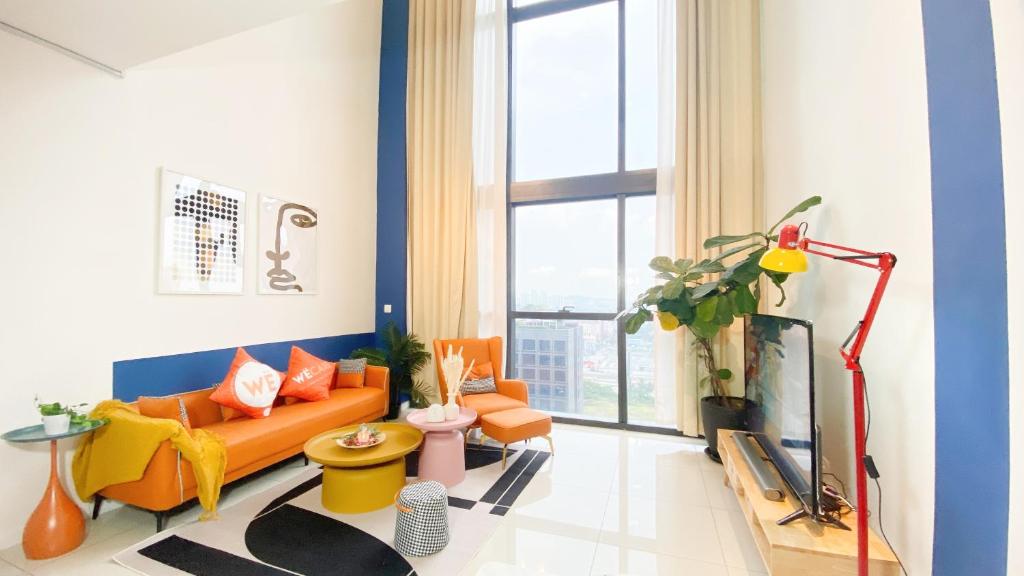 a living room with a couch and a tv at The Nordic - Icon City Petaling Jaya in Petaling Jaya
