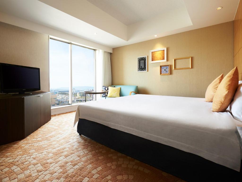 a hotel room with a large bed and a large window at Hotel Universal Port in Osaka
