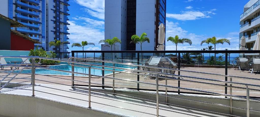 a balcony with a view of a swimming pool at Apto no D'ouro Park in Ilhéus