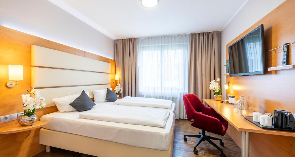 Postel nebo postele na pokoji v ubytování PLAZA INN Braunschweig City Süd