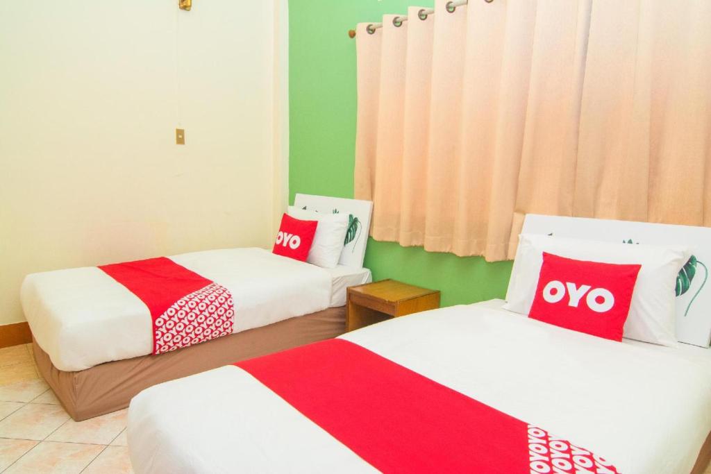 Postel nebo postele na pokoji v ubytování OYO 534 Phasuk Hotel