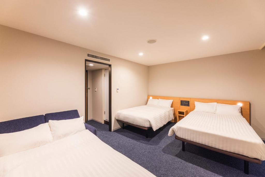 Postel nebo postele na pokoji v ubytování Sotetsu Fresa Inn Nagano-Ueda