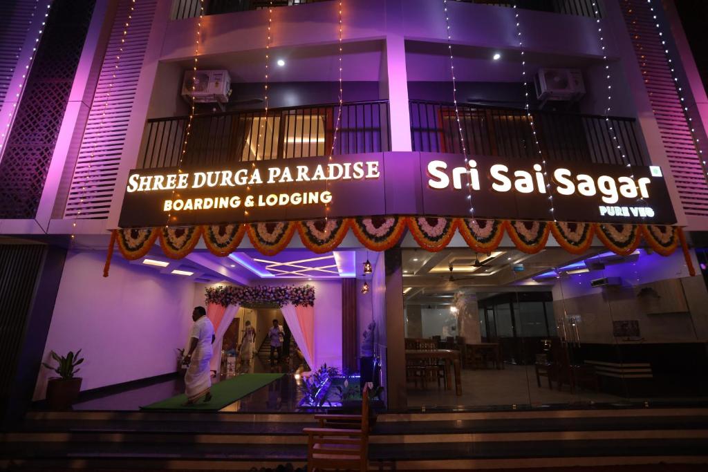 a man standing in front of a building at night at Shree Durga Paradise in Kalyānpur