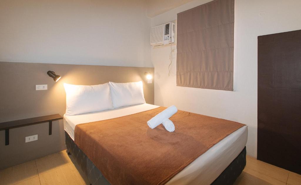 Postel nebo postele na pokoji v ubytování 59 Xavierville by RedDoorz