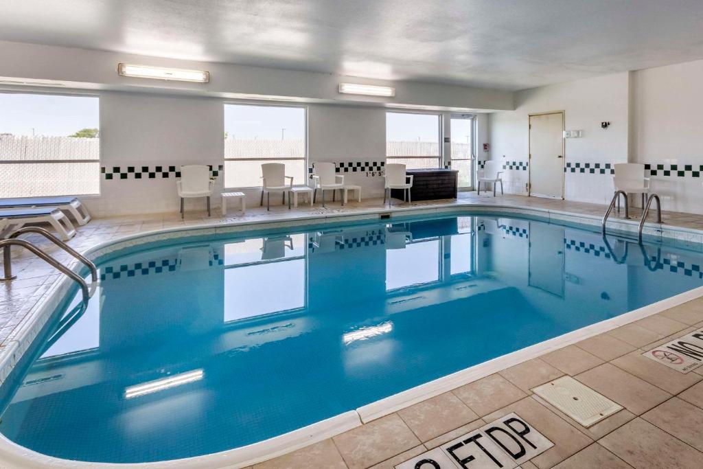 a large swimming pool with blue water in a building at Comfort Inn Great Falls South in Great Falls