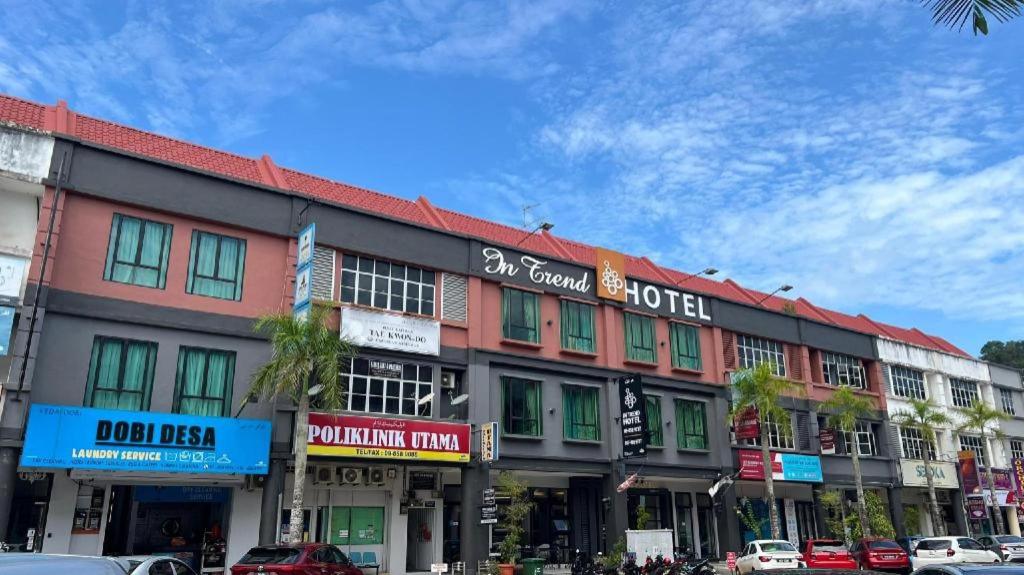 a large building on a city street with cars parked at In Trend Hotel in Cukai