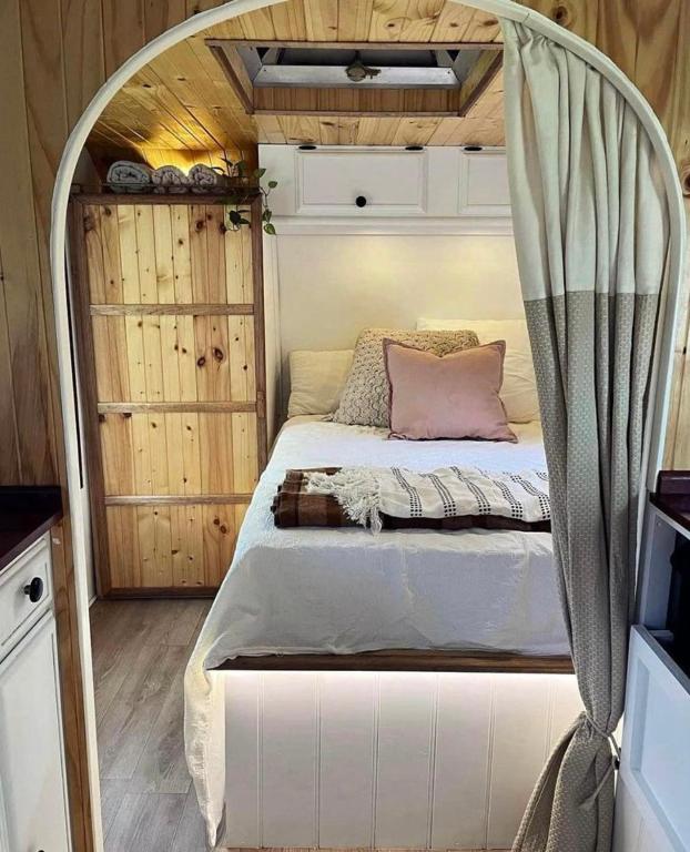 a bed with a canopy in a room at Vintage Coral Pink in Nelly Bay