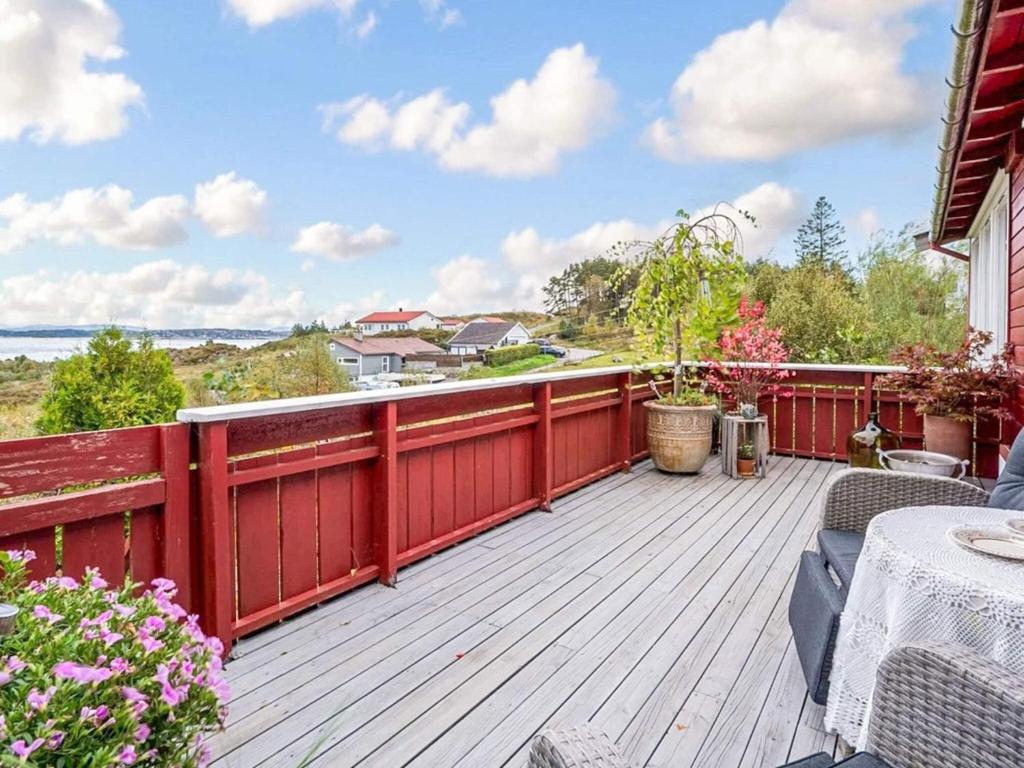 a wooden deck with a table and chairs on it at 5 person holiday home in KLOKKARVIK in Klokkarvik