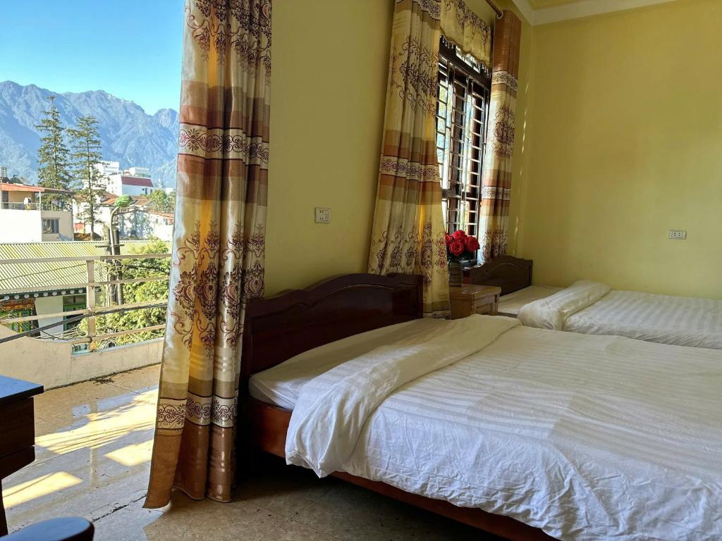 a bedroom with a bed and a window with a view at Suong May Sapa Homestay & Trekking in Sa Pa