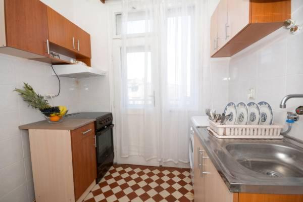 a small kitchen with a sink and a window at Apartments City Hall in Belgrade