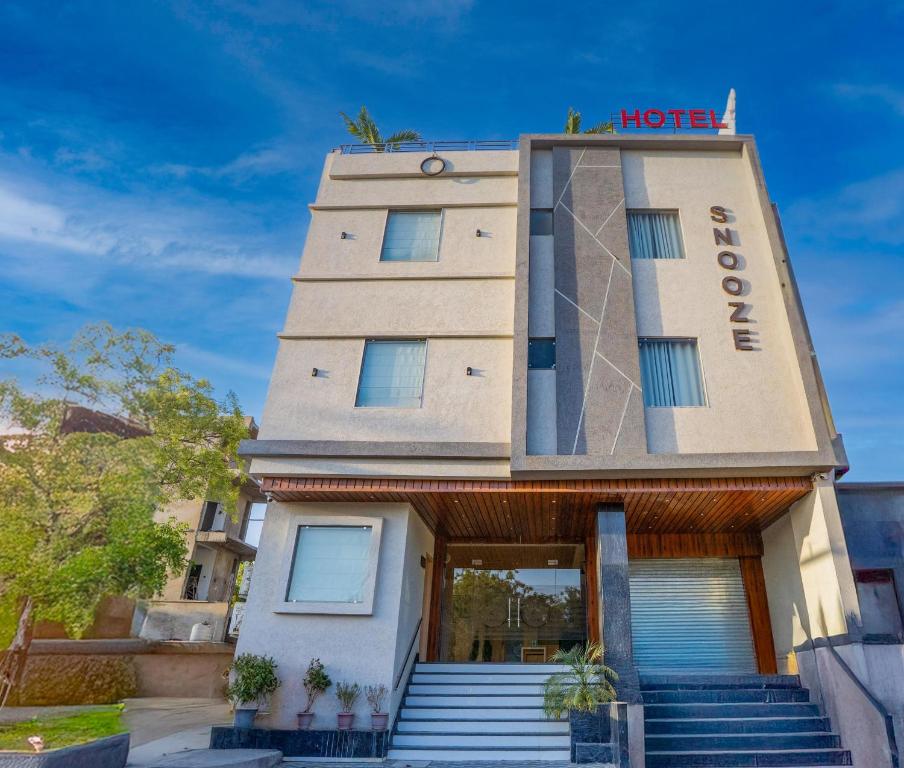 a hotel with stairs leading to the entrance at HOTEL SNOOZE in Jaipur