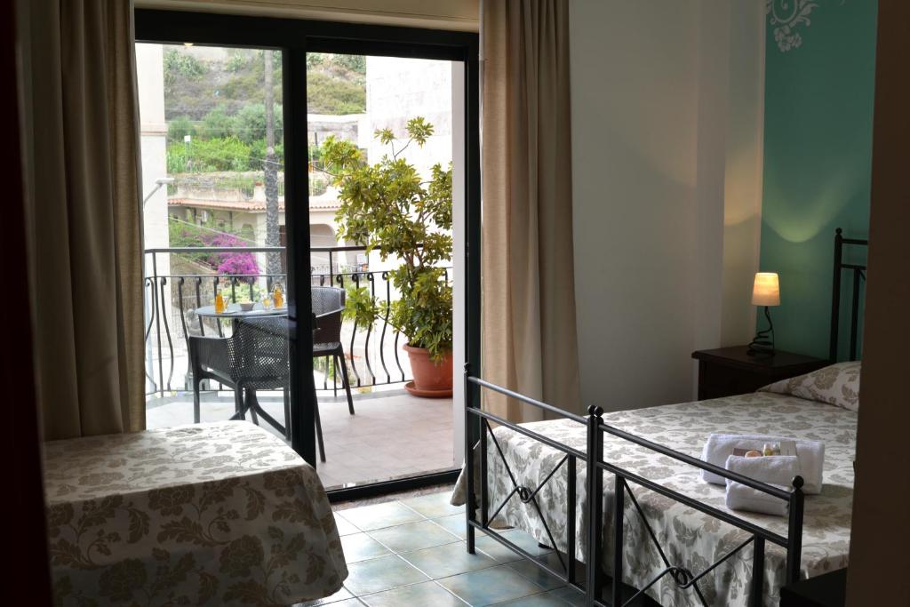 Postel nebo postele na pokoji v ubytování Hotel Donna Rosa