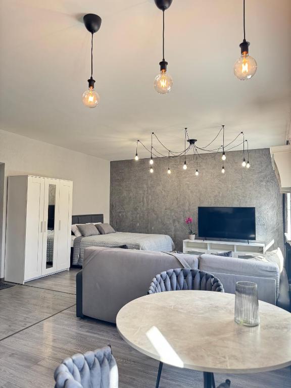 a living room with a couch and a table at EVIS LTD apartments 5 in Rēzekne