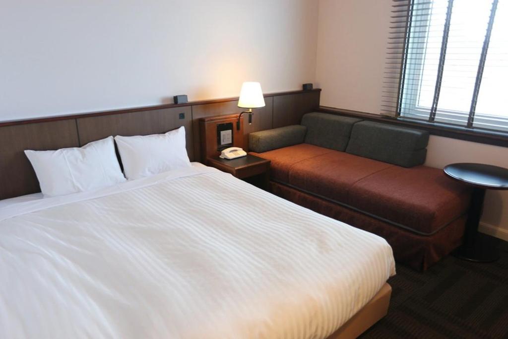 Postel nebo postele na pokoji v ubytování Hotel Castle Inn Tsu