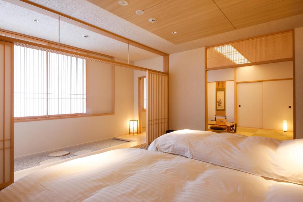 Postel nebo postele na pokoji v ubytování Hotel Honnoji