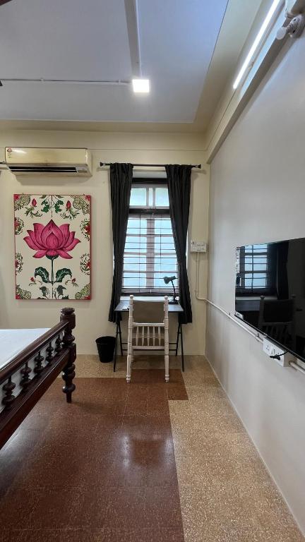 a room with a bed and a window at Sasha in Mumbai