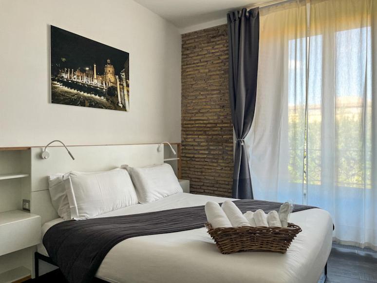 Ένα ή περισσότερα κρεβάτια σε δωμάτιο στο Arch Rome Suites