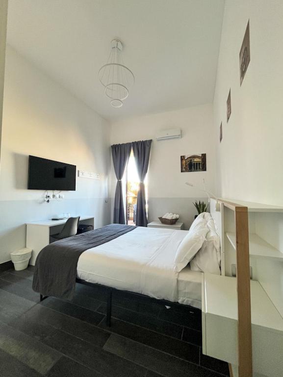 Ένα ή περισσότερα κρεβάτια σε δωμάτιο στο Arch Rome Suites