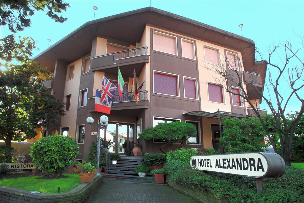 a building with a sign in front of it at Hotel Alexandra in Vinci