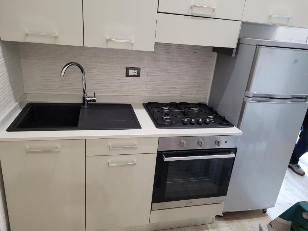 a kitchen with a stove and a sink and a refrigerator at Casa Gioia in Peschici