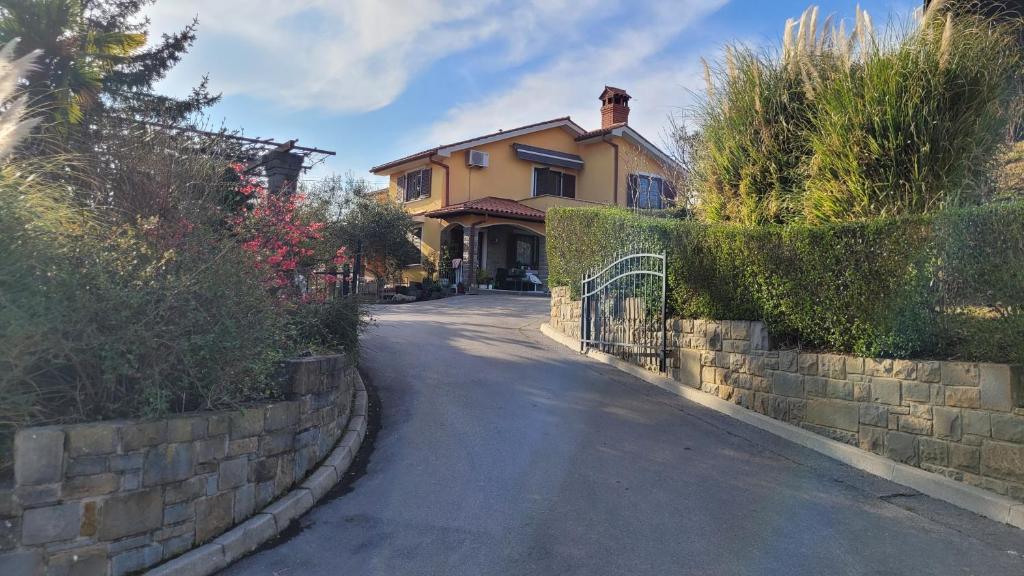 a house with a fence on the side of a road at Mar Apartments in Portorož