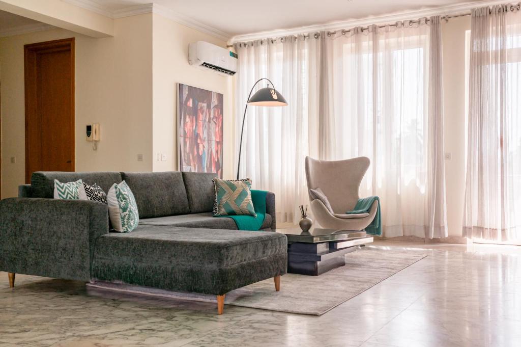 a living room with a couch and a chair at Pentridge 3-Bed Haven in Lagos