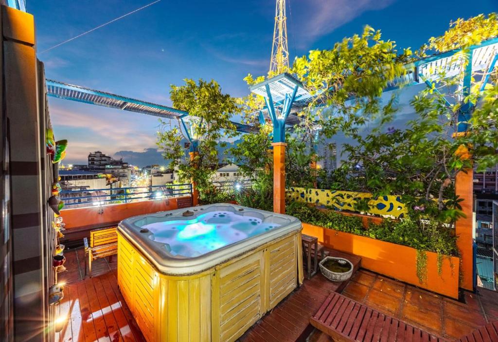 a hot tub on a balcony with a view of the eiffel tower at Collection O Diamond House Khaosan in Bangkok