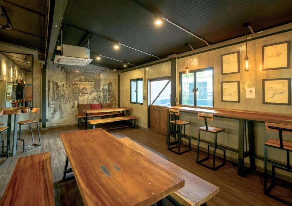 a pub with a wooden table and a bar at Episode 11 Hostel Sukhumvit in Bangkok