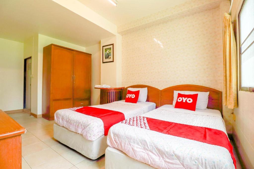 Postel nebo postele na pokoji v ubytování OYO 583 Sweethome Guest House