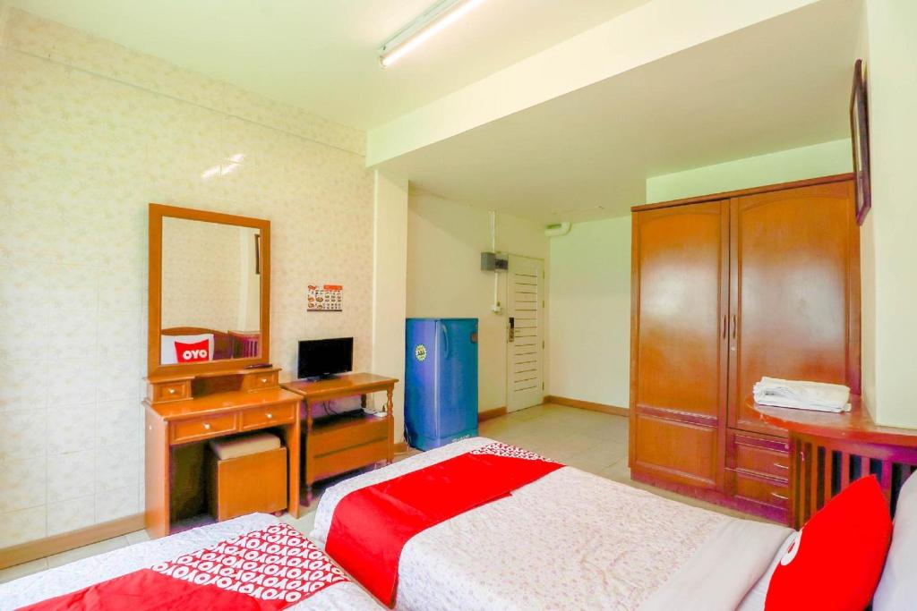 Postel nebo postele na pokoji v ubytování OYO 583 Sweethome Guest House