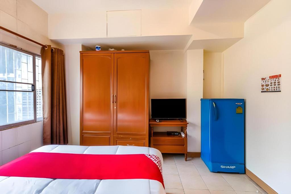 Postel nebo postele na pokoji v ubytování OYO 583 Sweethome Guest House