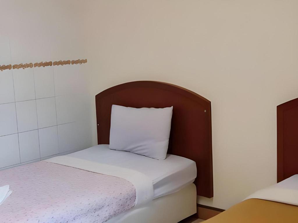 Postel nebo postele na pokoji v ubytování OYO 583 Sweethome Guest House