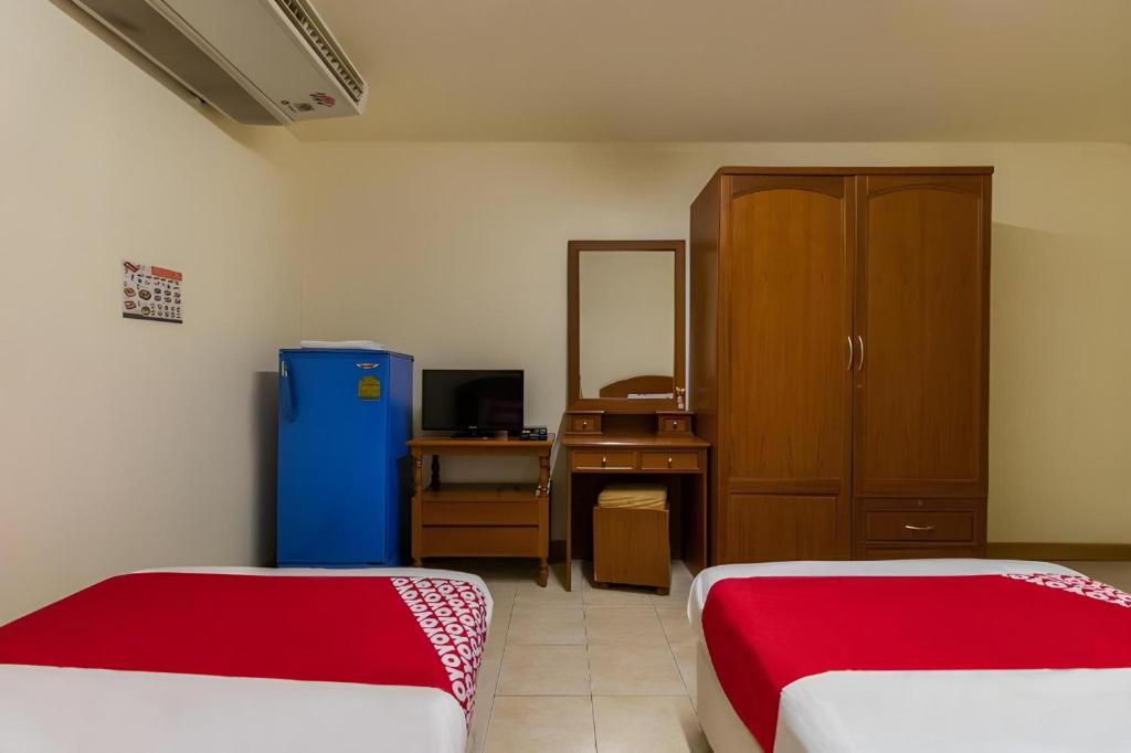Postel nebo postele na pokoji v ubytování OYO 583 Sweethome Guest House