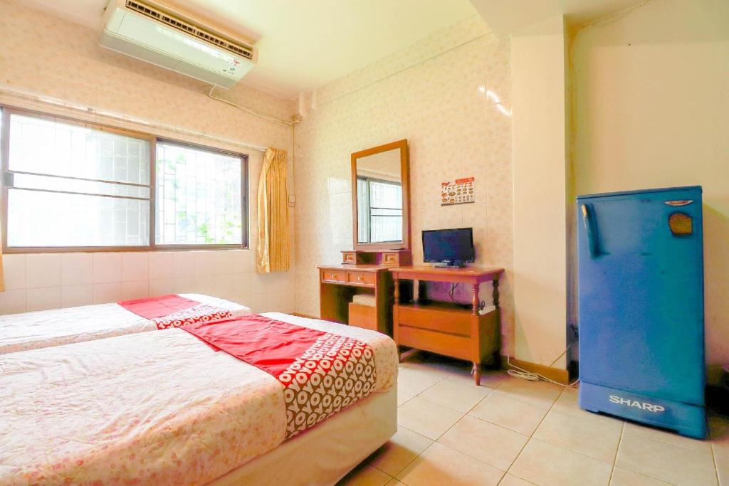 Postel nebo postele na pokoji v ubytování OYO 583 Sweethome Guest House