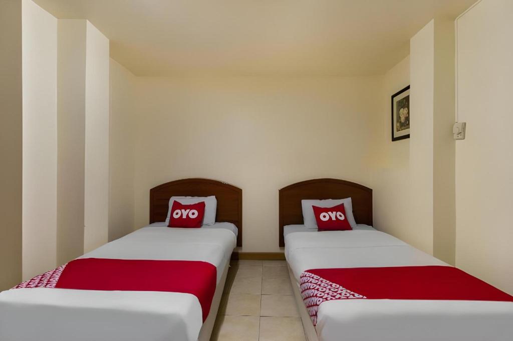 Postel nebo postele na pokoji v ubytování OYO 583 Sweethome Guest House