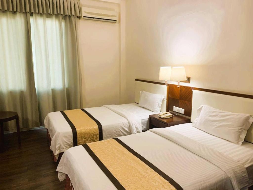 Postel nebo postele na pokoji v ubytování OYO 91037 Atari Inn