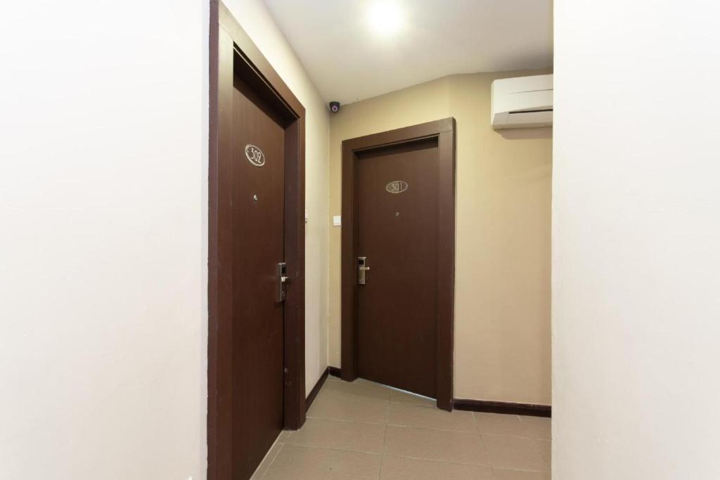 an empty hallway with two doors and a hallwayngth at Capital O 89344 Labuan Avenue Hotel in Labuan