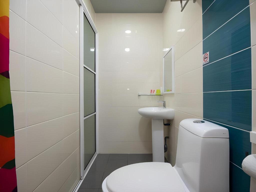 a bathroom with a toilet and a sink at Capital O 89344 Labuan Avenue Hotel in Labuan