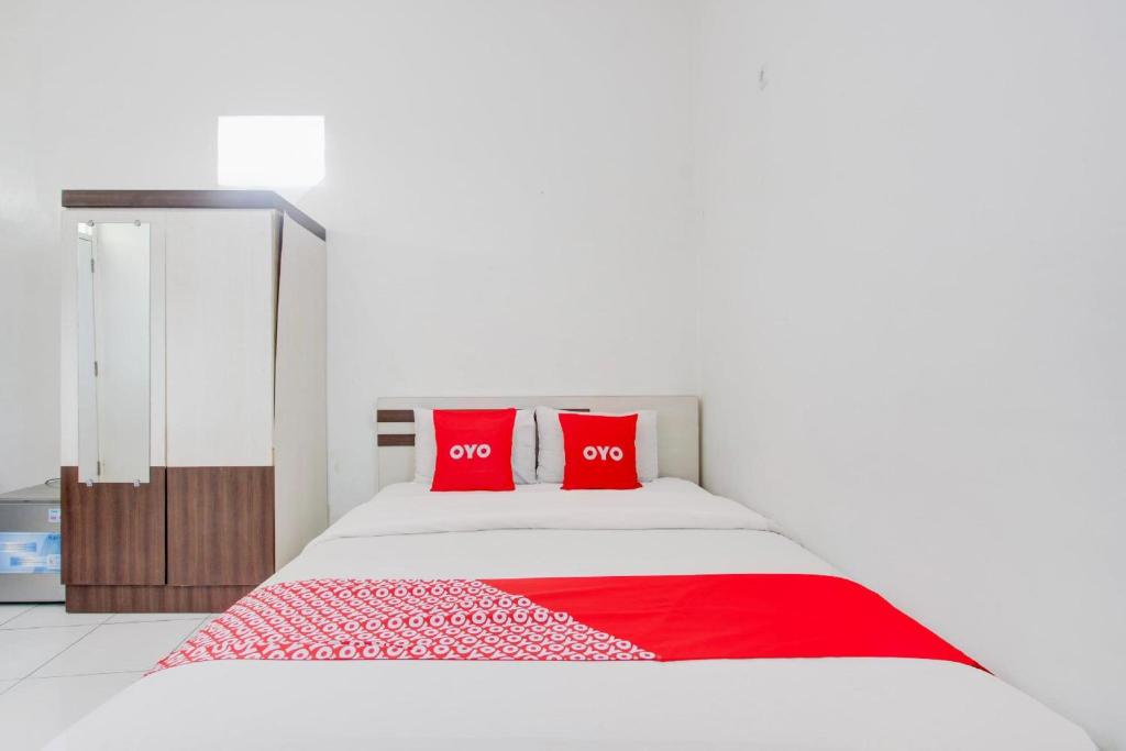 Postel nebo postele na pokoji v ubytování Hotel O Wisma Arya 2