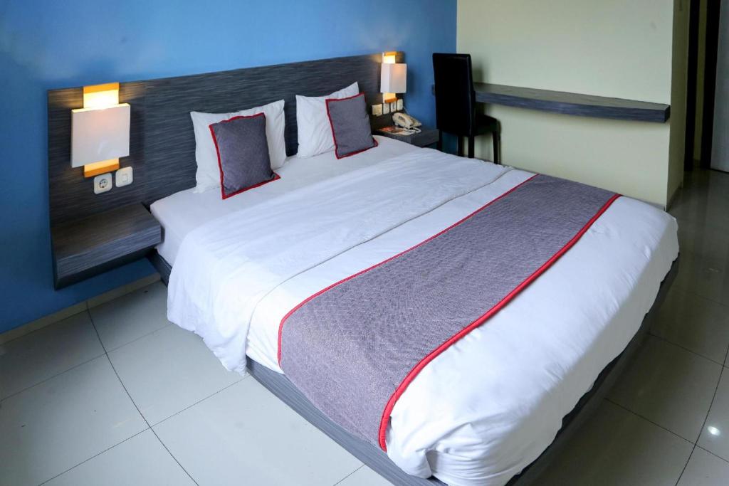Postel nebo postele na pokoji v ubytování Super OYO Townhouse OAK Hotel Fiducia Pondok Gede